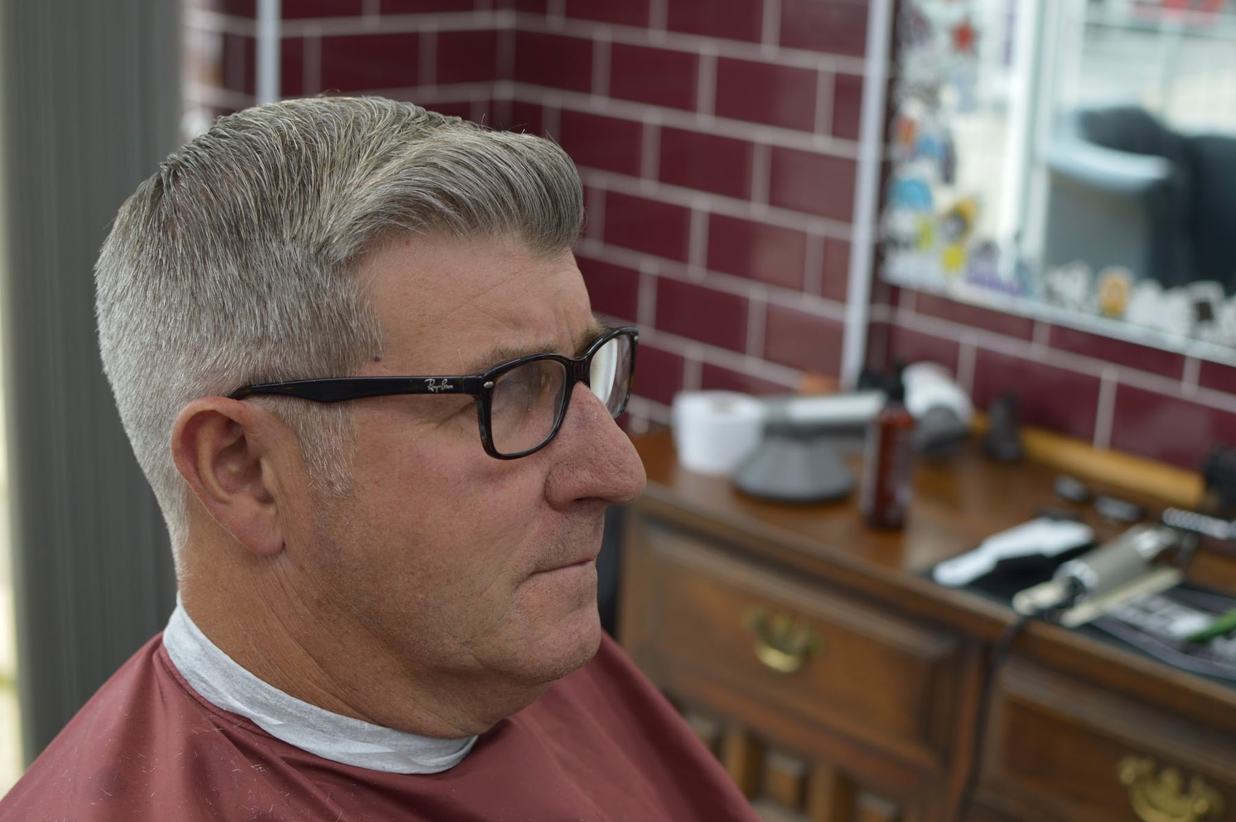 Neatly tapered grey haircut
